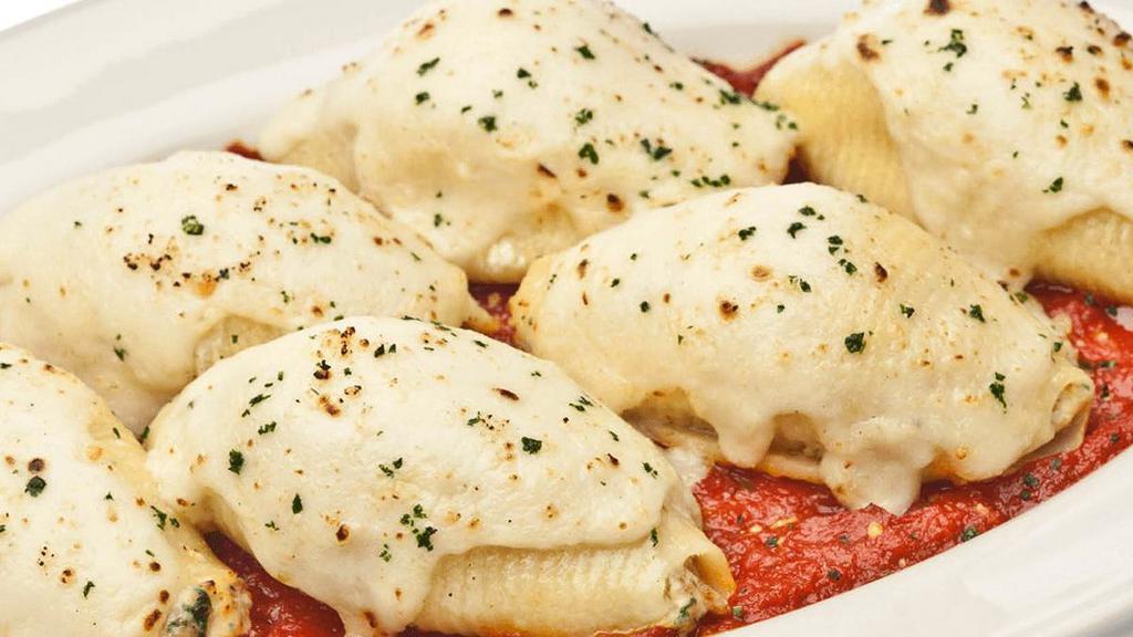 Stuffed Shells · pasta shells filled with spicy Italian sausage, spinach, ricotta & parmesan with Alfredo & our homemade marinara sauce . {SP}