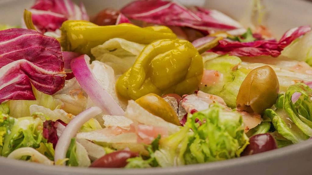 Mixed Green · Mixed lettuce tossed in our signature Italian vinaigrette with Roma tomatoes, red onions, pepperoncini and black & green olives . {VT, GF}