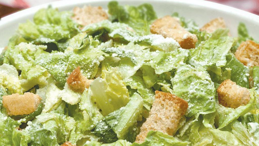 Caesar · Romaine hearts tossed in our signature Caesar dressing with roasted garlic croutons & parmesan