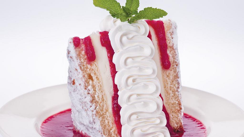 Italian Creme Cake · Six layers of rich lemon cake and mascarpone cheese filling, served in a pool of raspberry sauce and topped with whipped cream