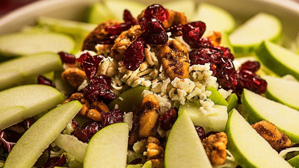 Apple Gorgonzola · Granny Smith apples, spiced walnuts, dried cranberries & Gorgonzola tossed with mixed lettuce in our signature Italian vinaigrette.