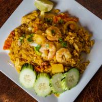 Pineapple Fried Rice · Chicken and prawns, egg, onions, peas, carrots, cashew nuts, pineapple, and curry powder.