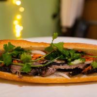 BM8. Wood-Smoked Brisket · Wood-smoked brisket with barbecue sauce in a Vietnamese style baguette.