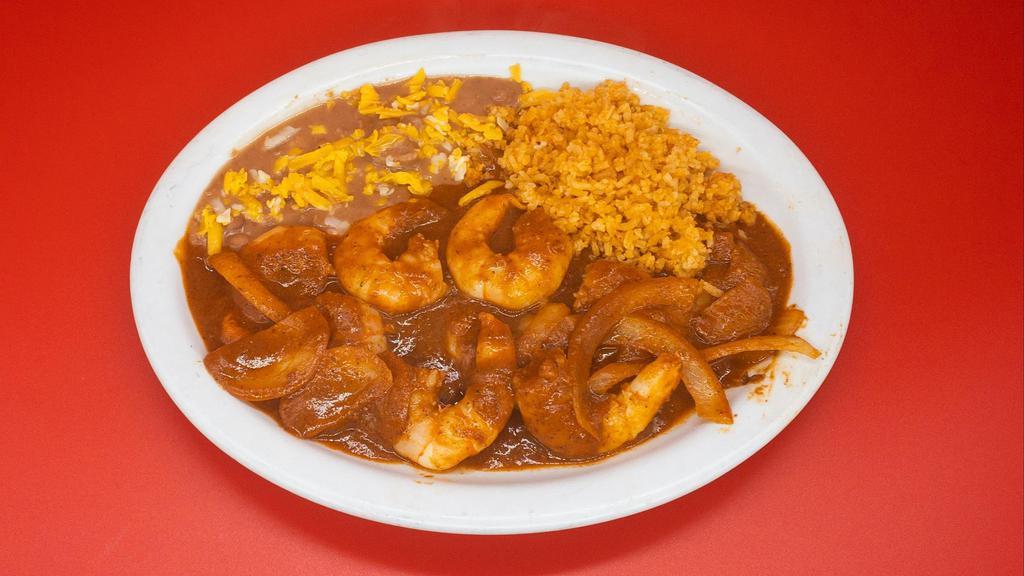 Camarones a la Diabla · Our camarones a la diabla are juicy large shrimp cooked in a flavorful and spicy red chile sauce served with a side of rice and beans.