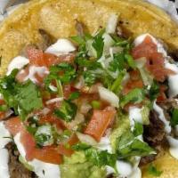 Super Taco de Asada · Our super taco is made with a large tortilla topped with meat, cheese, pico de gallo, guacam...