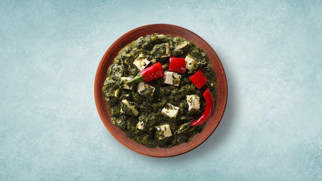 Cottage Cheese In Spinach · Cottage cheese cooked in spinach curry with spices and onion, garlic and tomato. Served with a side of rice.