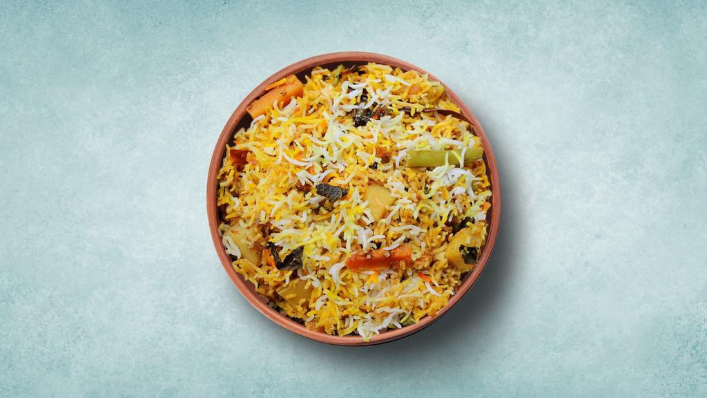 Aromatic Vegetable Biryani  · Imported basmati rice cooked with fresh assorted dished vegetables cooked with our special homemade fresh herbs and spices.. Served with lightly spiced curry and raita.