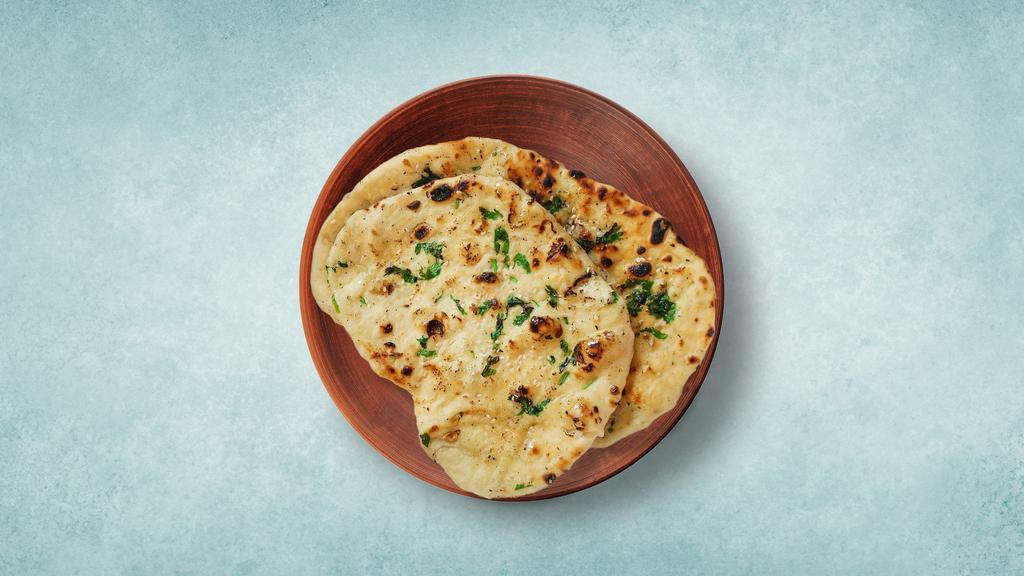 Butter Naan · Leavened refined wheat  flatbread baked in a tandoor clay oven and topped with butter.