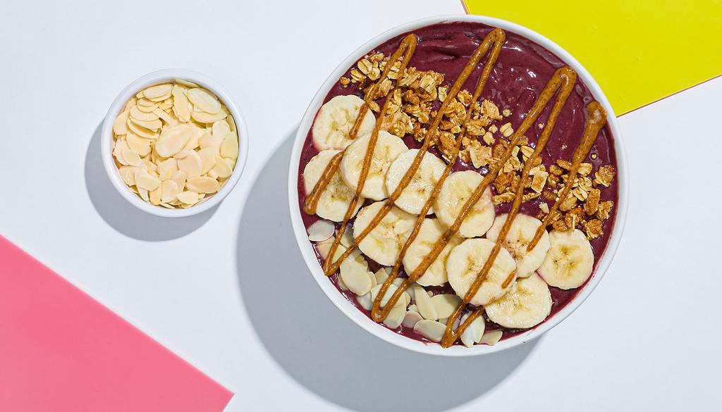 Almond Acai Bowl · Refreshing acai topped with bananas, granola, almond butter, and almonds.