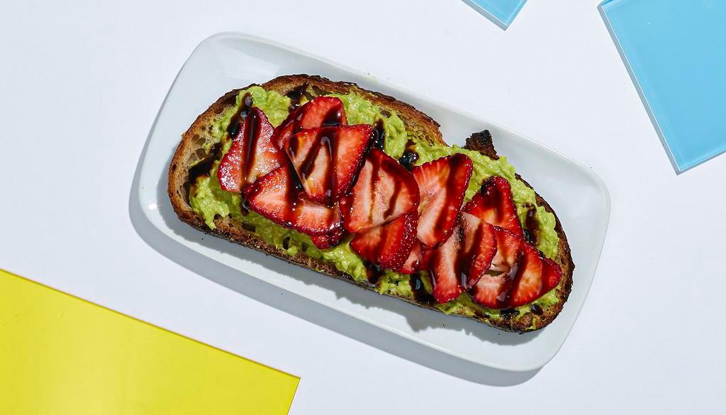 Strawberry Avocado Toast · Smashed avocado on whole wheat toast topped with strawberries and balsamic.