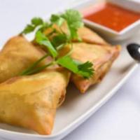 Samosas · Vegetarian. Flour turnover filled with potatoes, red onions, peas, carrots and a blend of un...