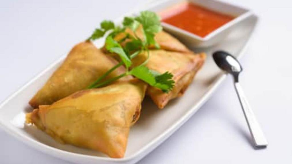 Samosas · Vegetarian. Flour turnover filled with potatoes, red onions, peas, carrots and a blend of unique spices served with special house sauce.