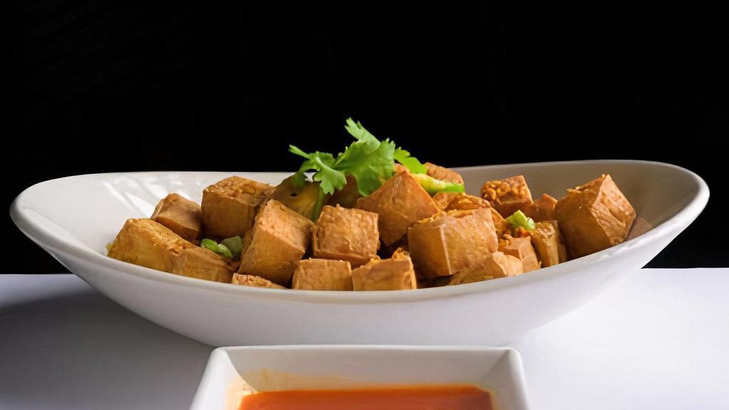 (C) Fried Tofu · Deep fried soft tofu seasoned and served with a tangy chili sauce.
