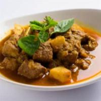 Burmese Curried Pork · Pork simmered in curry served with potatoes and pickled mangoes.