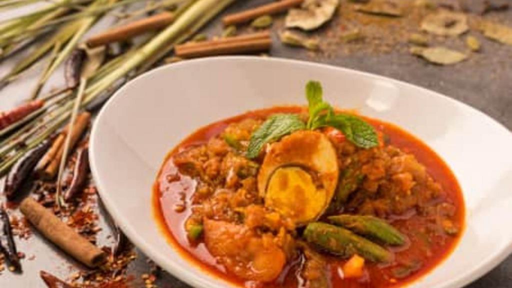 Egg & Okra Curry · Red Burmese curry prepared with tomatoes, fried hard-boiled egg and okra.