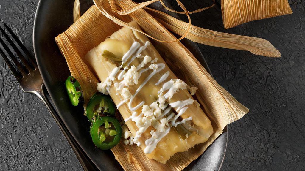 Tamale Asado · Your Choice of Tamale grilled and wrapped with cheese loaded with sour cream, refried beans & rice.