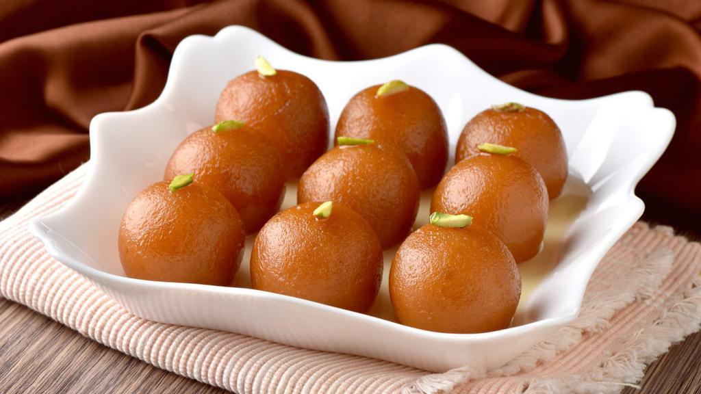 Gulab Jamun · Three pieces of fried dough balls soaked in a sweet, sticky sugar syrup.