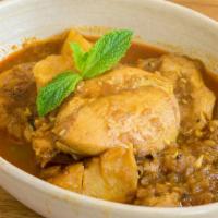 Burmese Style Chicken Curry · Gluten-free. Chicken curry slow-cooked with pickled mangoes, yellow chickpeas, potatoes, oni...