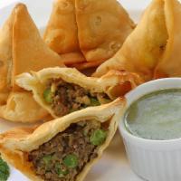 Meat Samosa · Pastry with ground lamb and peas.