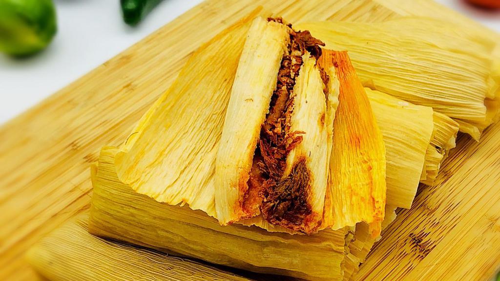 Beef Tamale · Shredded flank steak perfectly cooked in guajillo sauce, masa harina flour and vegetable oil wrapped in corn husks.