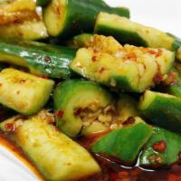 Cucumber Salad · Asian cucumbers cut and smashed, tossed in black vinegar, garlic, and chili oil.