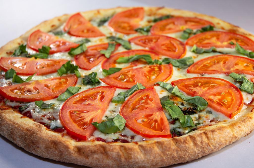 Margherita Pizza · Fresh basil, diced tomatoes, fresh garlic, and Mozzarella cheese.
