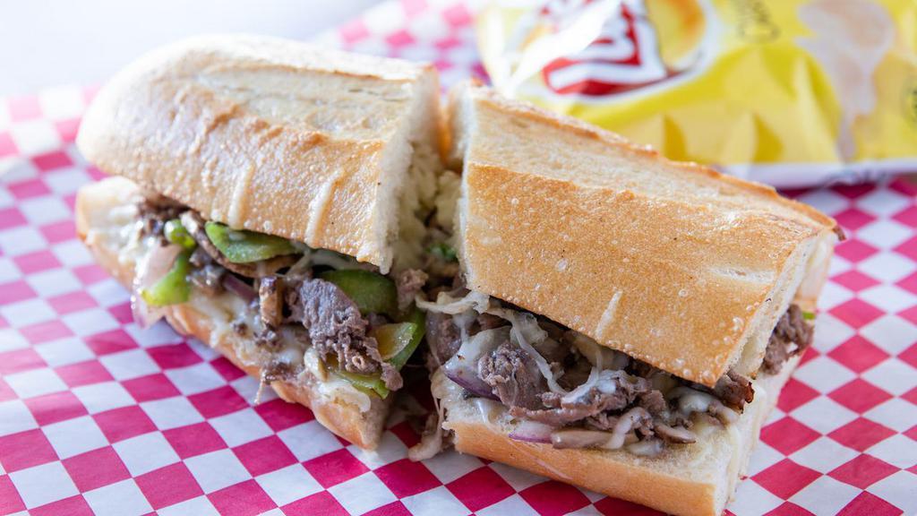Philly Cheesesteak Sandwich · Fully charged bread with philly steak melted with mozzarella, onions, green peppers, and mushrooms. All sandwiches include a bag of potato chips.