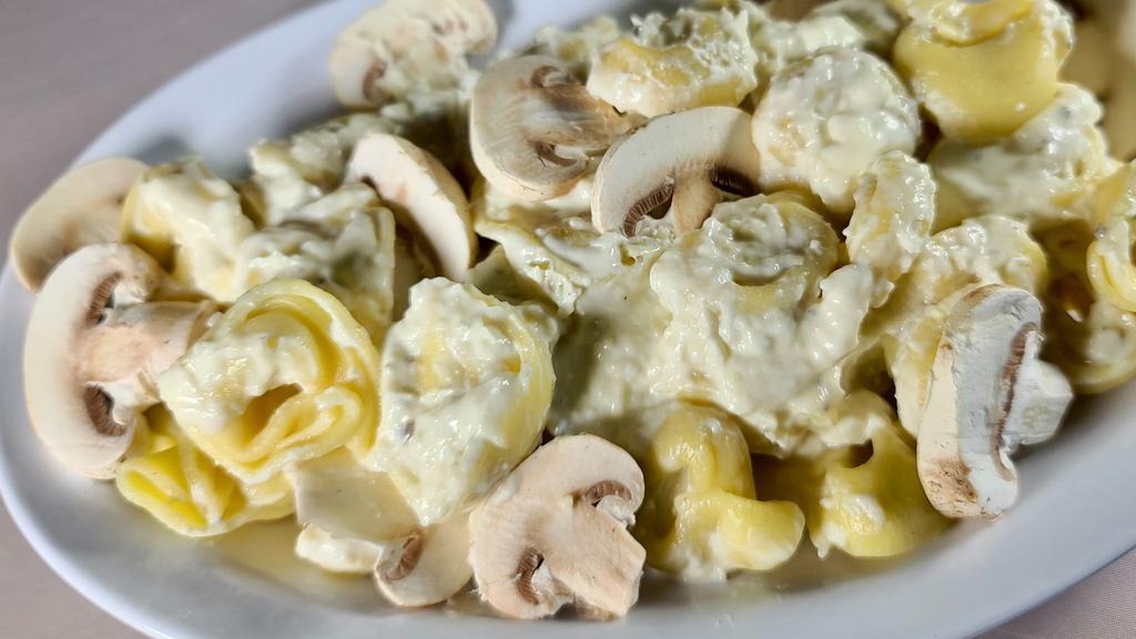 5 Cheese Tortellini · Served with mushrooms and Parmesan cream sauce or choose our pesto or traditional marinara sauce. All pasta dishes are served with garlic bread.