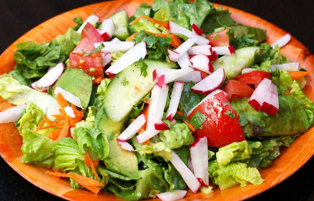 Garden Salad · Mixed greens, cherry tomatoes, cucumber, avocado, carrots, with dressing.