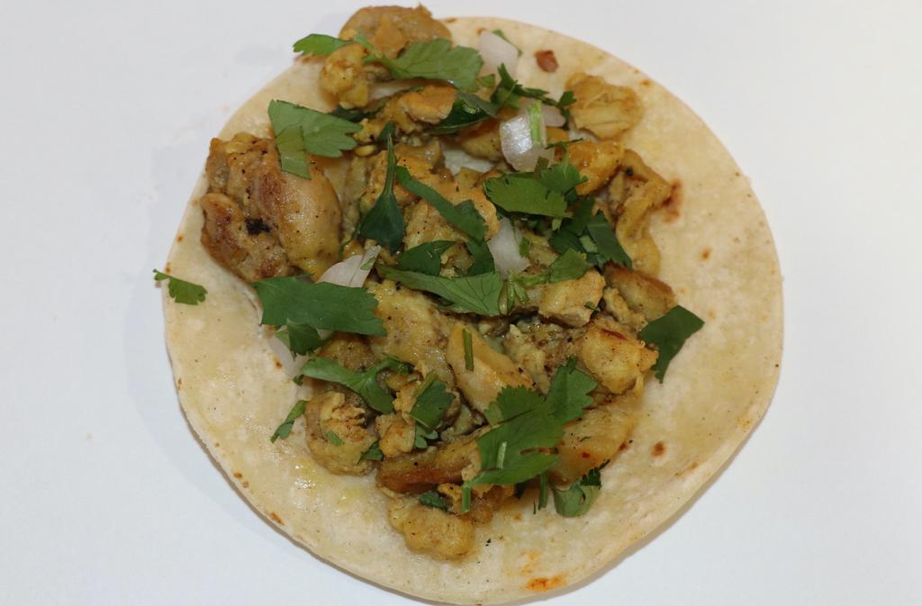 Taco De Pollo (Chicken) · Tender juicy chicken, cilantro, onions, and salsa in an organic corn tortilla.