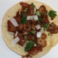 Taco de Tripa (Beef Tripe) · Beef tripe, cilantro, onions, and salsa in an organic corn tortilla.