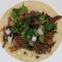 Taco De Cabeza (Beef Cheek) · Delicius beef cheek, cilantro, onions, and salsa in an organic corn tortilla.
