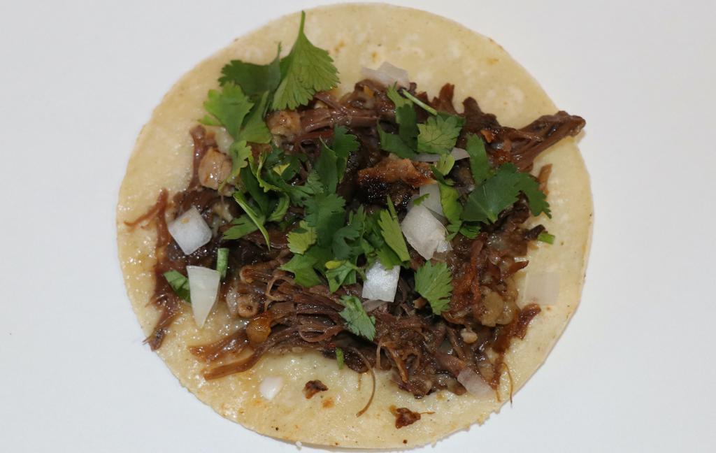 Taco De Cabeza (Beef Cheek) · Delicius beef cheek, cilantro, onions, and salsa in an organic corn tortilla.