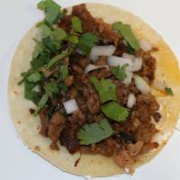 Taco de Suadero (Roasted Beef) · Roasted beef, cilantro, onions, and salsa in an organic corn tortilla.