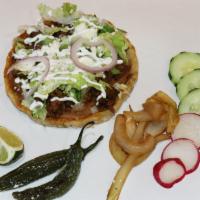 Sopes · Handmade corn tortilla, beans, choice of meat, lettuce, queso fresco, sour cream and salsa.