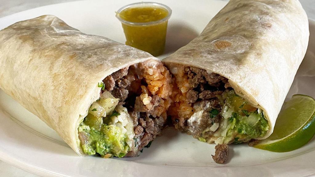 Flank Steak Super Burrito · Our delicious super burrito made with flank steak is the bomb. Made on a large tortilla, with rice, beans, flank steak, cheese, sour cream and guacamole and our salsa a la diabla.