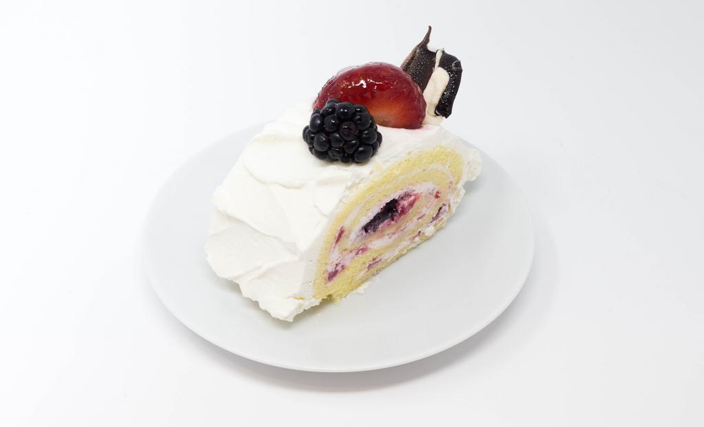 Berry Roll Cake Slice · Light and Fluffy Cake Roll with Blueberry Filling and Fresh Strawberries.