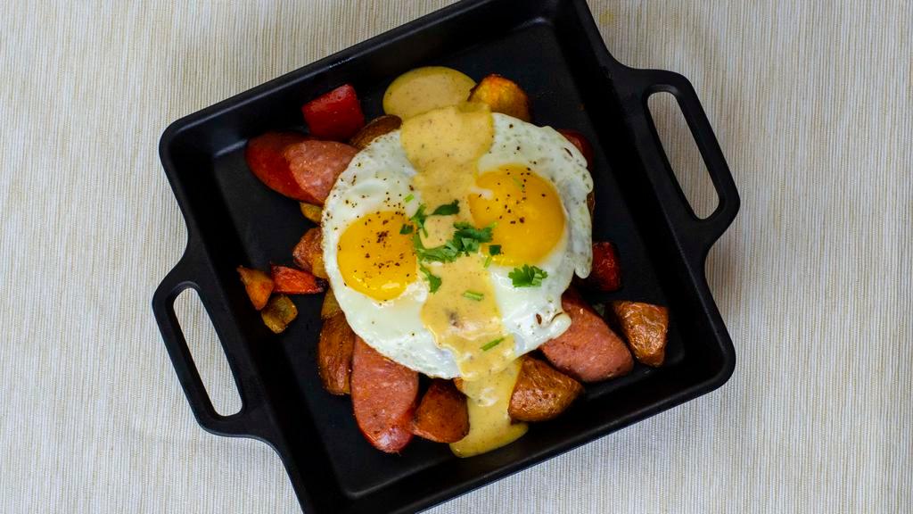 Cajun Benedict Skillet · 2 cage-free eggs cooked to order, andouille sausage, potatoes and vegetables.