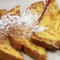French Toast · Two thick slices of Brioche bread dipped in a French batter and dusted with powdered sugar, ...