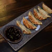 Gyoza · 6 house made dumplings filled with pork, ginger, garlic and cabbage, served with chef's spec...