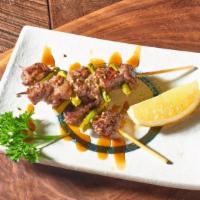 Grilled Beef Skewer · Grilled sizzling USDA bite-size Angus beef topped with special  sauce, served with fresh sli...