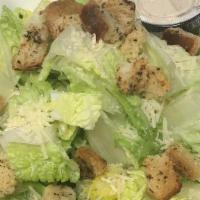 Caesar Salad · Romaine lettuce, homemade garlic croutons and parmesan cheese with a creamy Caesar dressing.