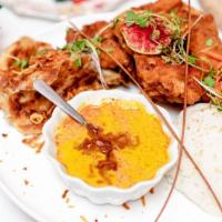 Pladaek Gai Tod · Southern-style fried chicken served with roti, fried onion, Panang curry, and fragrant cocon...