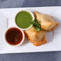 Samosa · Home style pastry puff with green peas and flavored potato.