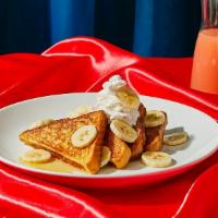 Banana French Toast · Two slices of thick, egg-washed cinnamon bread topped with fresh bananas, and strawberries, ...