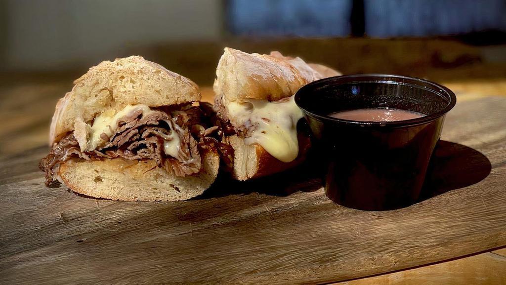 Mckay's Tridip Sandwich  · Marinated tri-tip sliced thinly & served on a Salt Craft roll with caramelized onion aioli, topped with Swiss cheese and paired with a red wine au jus.