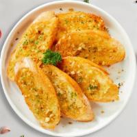 Grand Garlic Bread Jury · Housemade bread toasted and garnished with butter, garlic, and parsley.