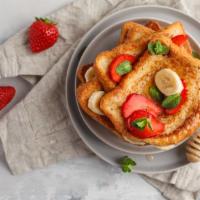 Strawberry Banana French Toast · 2 slices of Classic French Toast freshly prepared and cooked to perfection. Topped with fres...