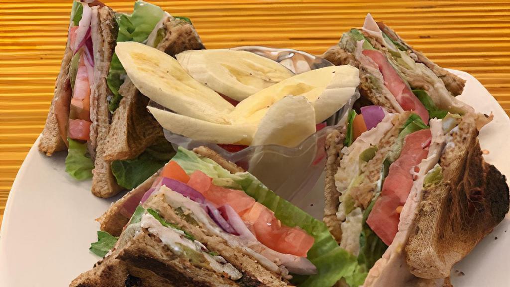 Club Sandwich · Fresh Cut Ham, Roasted Turkey, Bacon,  Lettuce, Tomato, Onion, Avocado, and Chipotle Mayonnaise. Served with your choice of White, Wheat, or Sourdough bread. Also served with a side of  fresh fruit.