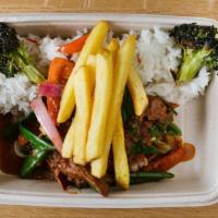 Lomo Saltado · Stir-fried beef tenderloin with onions, tomatoes, gluten free soy sauce and fries.